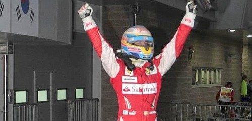 Ferrari Formula One driver Fernando Alonso of Spain celebrates on his car after winning the South Korean F1 Grand Prix at the Korea International Circuit in Yeongam