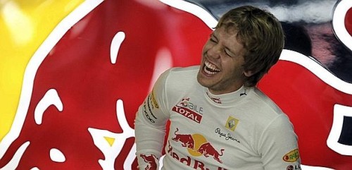 Red Bull Formula One driver Sebastian Vettel of Germany laughs inside the pits at the Interlagos racetrack